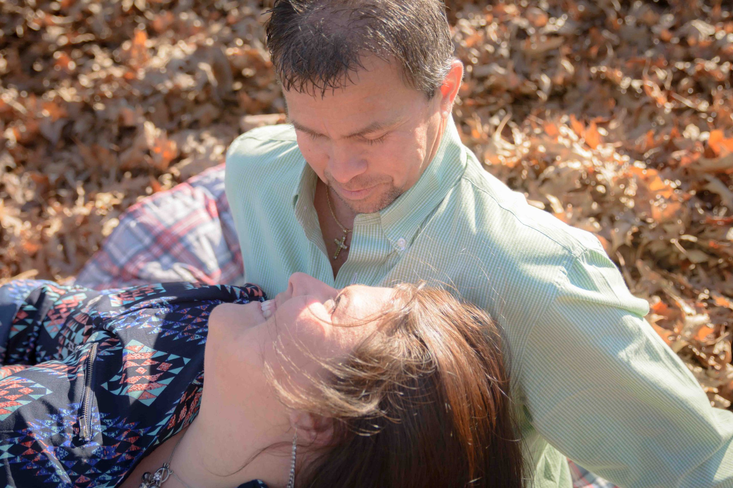 playing in the fall leaves at engagement shoot